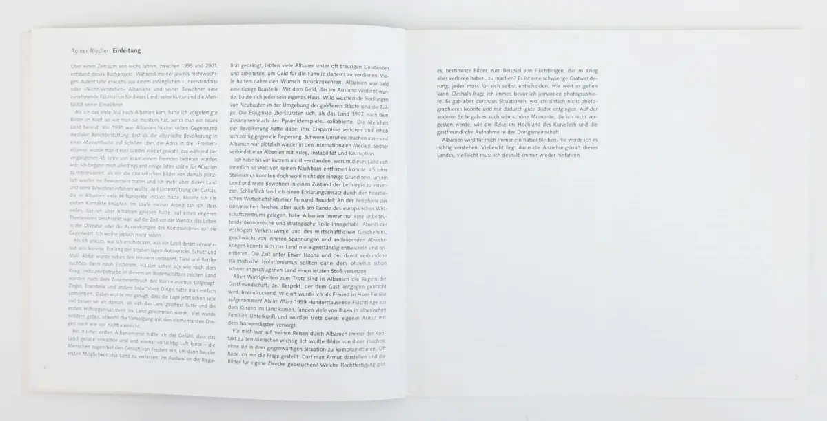 Open book laid flat on a white surface, displaying two pages of dense German text.