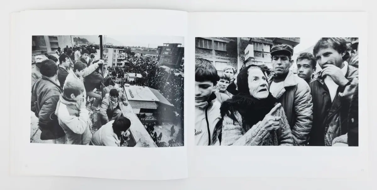 Two-page photo spread: left shows crowd on rooftop overlooking city street; right shows elderly woman in scarf and a man with cap among onlookers.