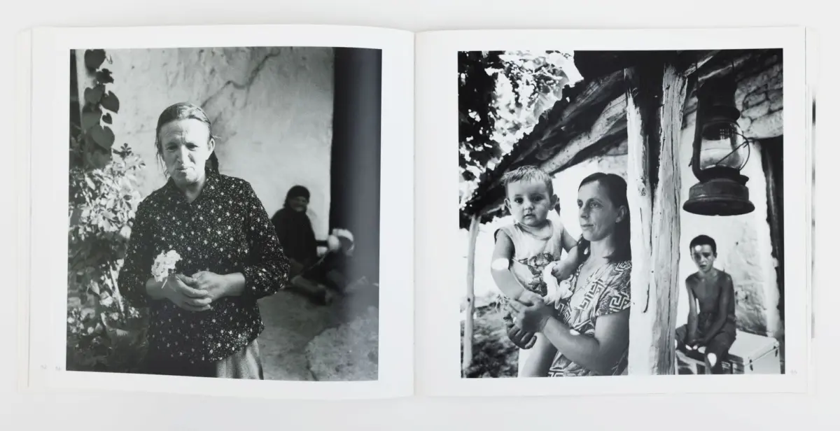 Black-and-white spread: left, elderly woman in floral blouse holds a flower outside; right, mother with baby near a wooden post and lantern.