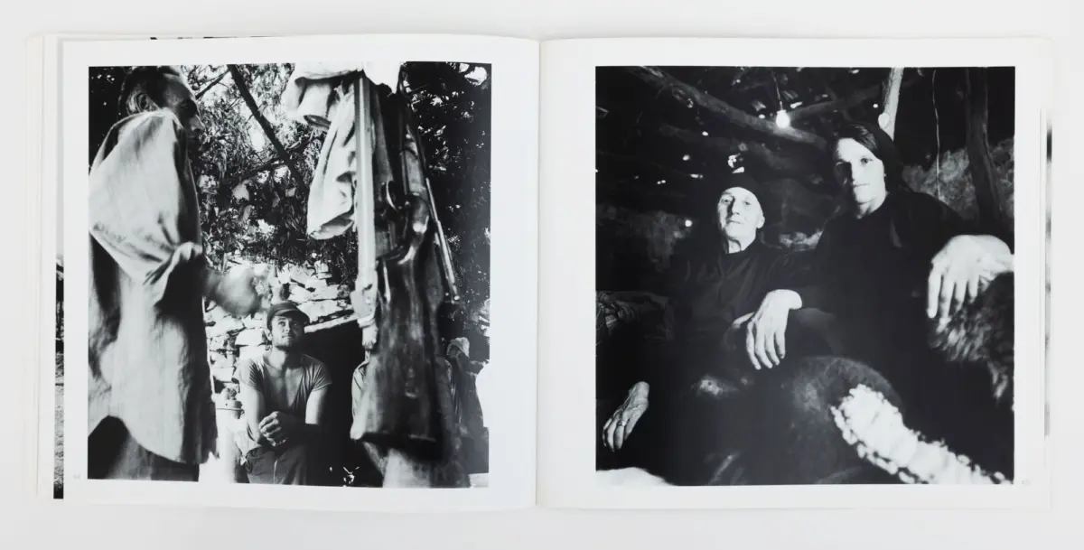 Two-page black-and-white photo spread; left: a seated person amid foliage with a standing figure in a coat; right: two people under a tree.