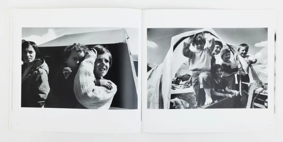 Two-page black-and-white photo spread: left shows three children by a tent; right shows children aboard a boat lifting a canopy.