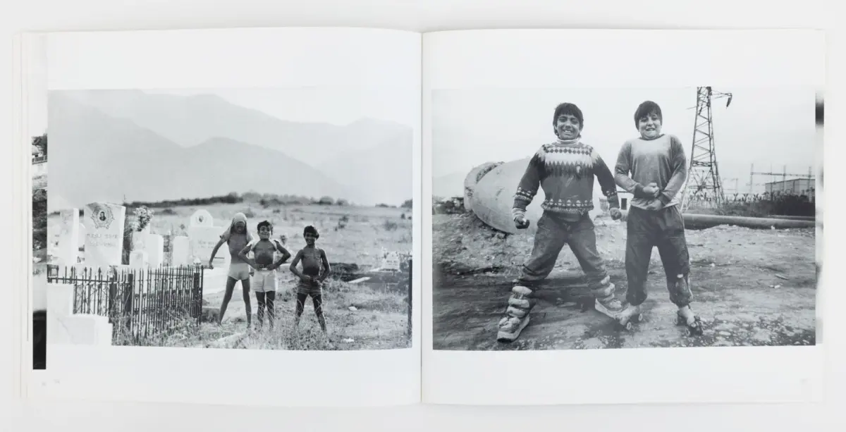 Two-page spread: left, three children by graves in a mountain cemetery; right, two boys pose with fists at an industrial site with a power tower.