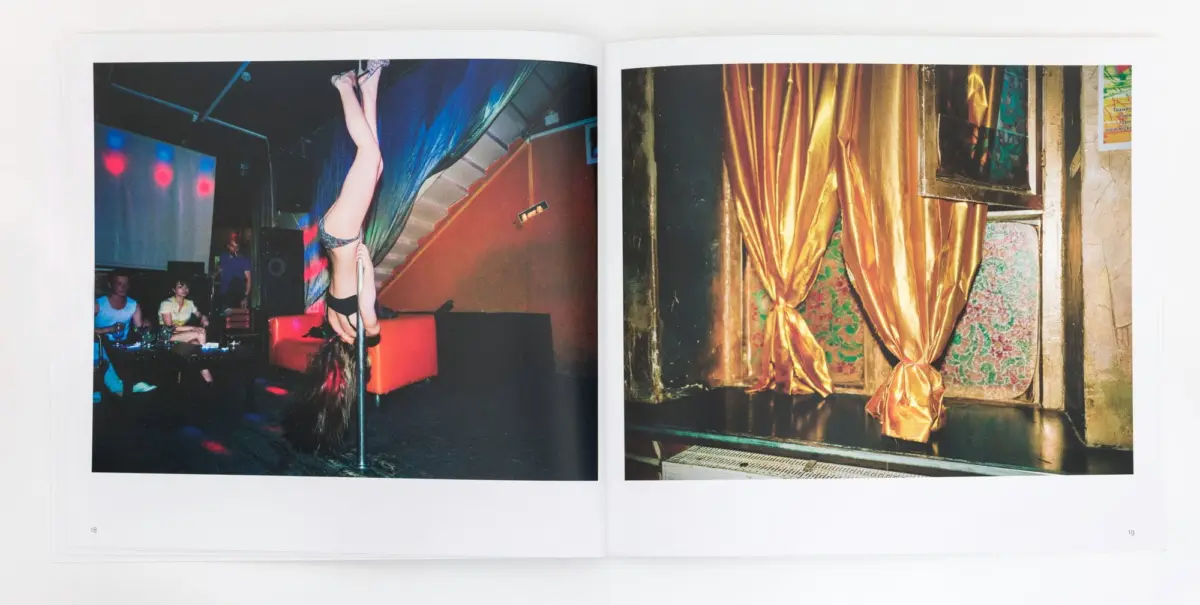 Two-page spread: left shows a pole dancer upside down on a pole in a nightclub with spectators; right shows gold curtains over floral wallpaper.