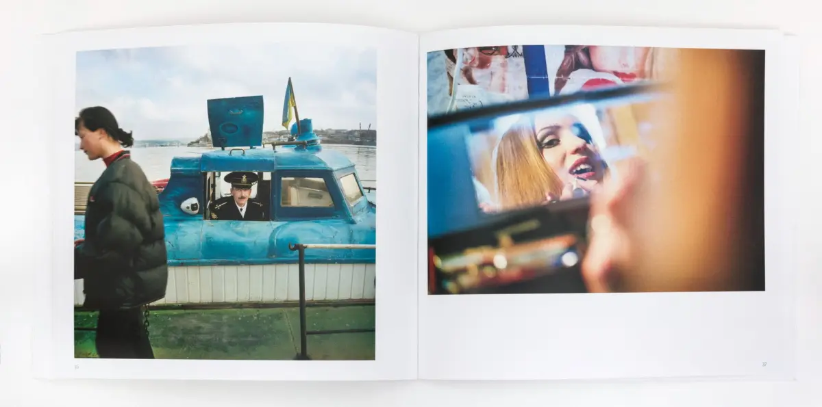 Blue patrol boat with uniformed captain at harbor; foreground pedestrian passes by. Woman applies lipstick in a mirror.