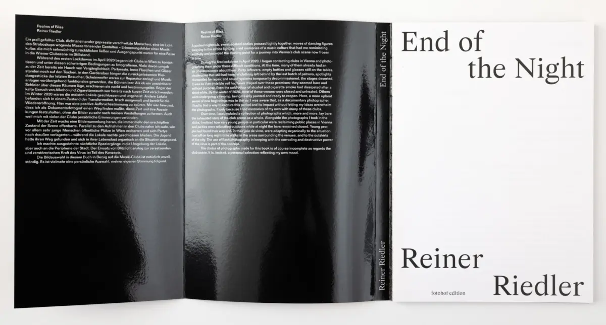 Open photobook spread; left glossy black pages with dense German/English text, right white page with large title “End of the Night.”