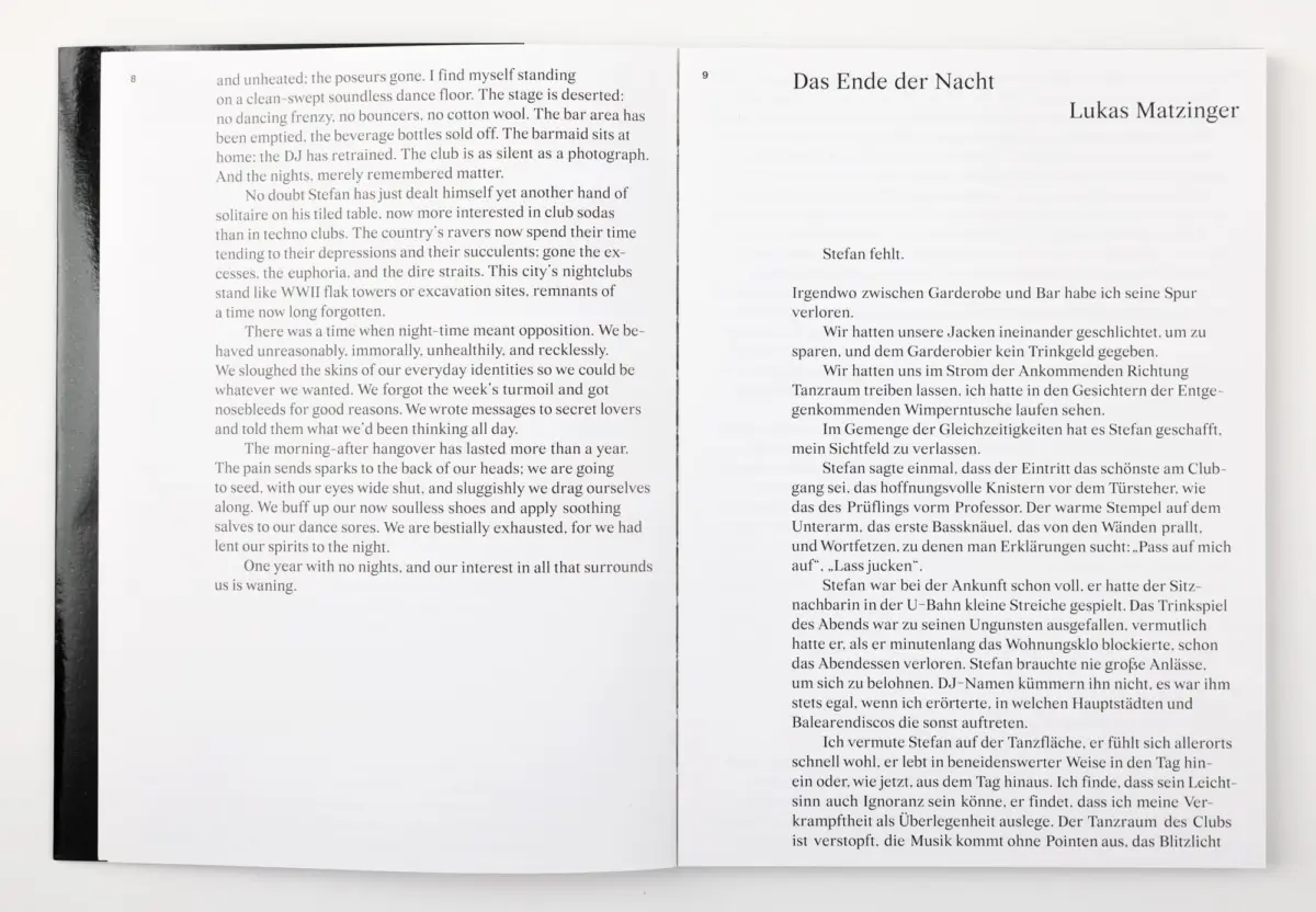 Open book on a white surface; left page English prose, right page German text with title 'Das Ende der Nacht' by Lukas Matzinger.