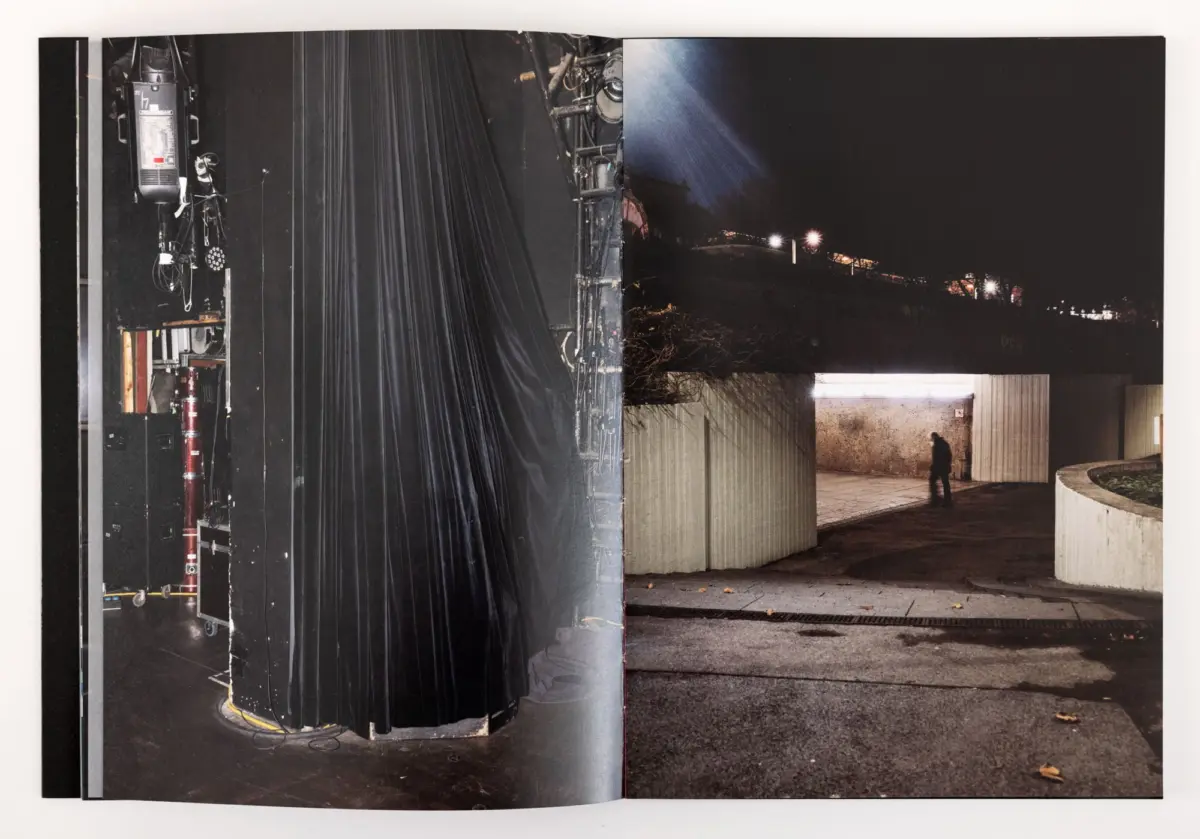 Backstage theater area with a thick black curtain and stage rigging; night exterior view with a person walking along a curved wall.