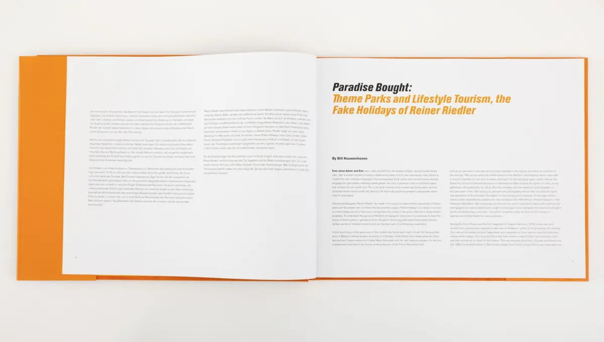 Open magazine spread with orange cover on white surface; right page shows bold title Paradise Bought: Theme Parks and Lifestyle Tourism.