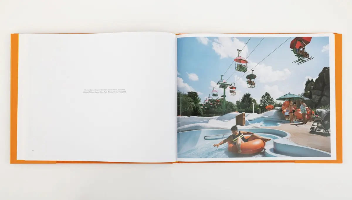 Open book depicting Typhoon Lagoon water park: colorful chairlift gondolas above winding water slides, and sunlit visitors.