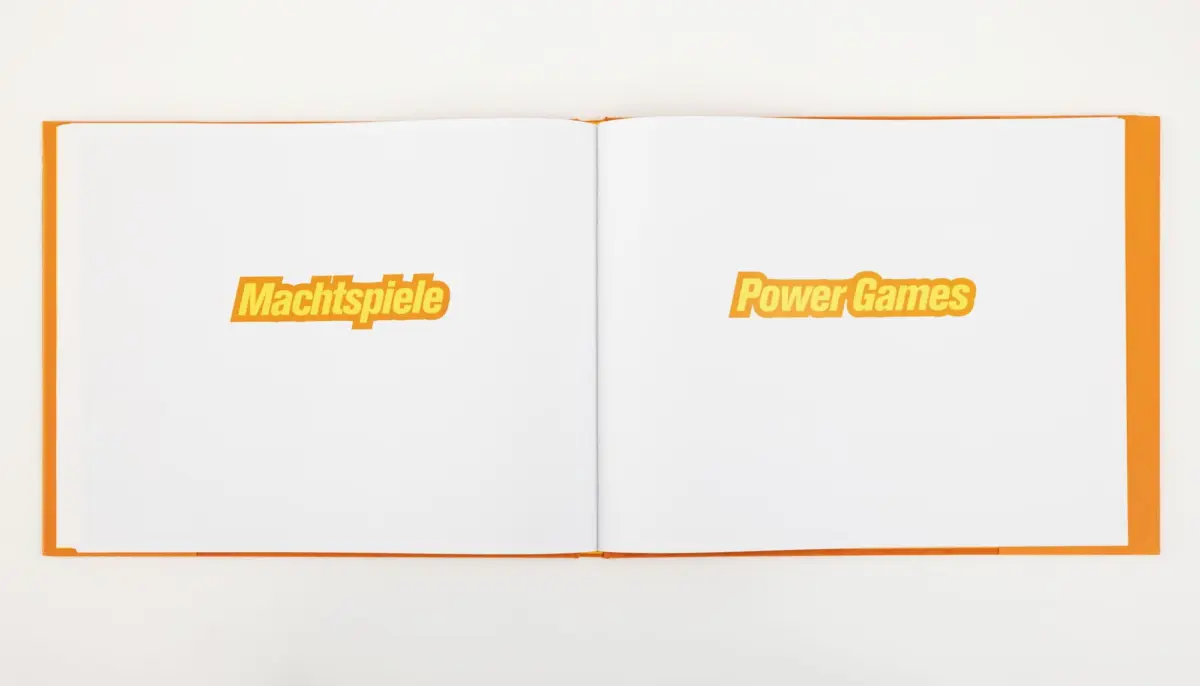 Open orange-edged book, two-page spread with bold orange text Machtspiele on the left and Power Games on the right.