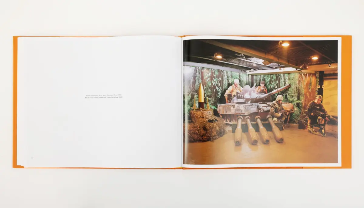 Color photo of a military tank with soldiers in a jungle-themed indoor diorama