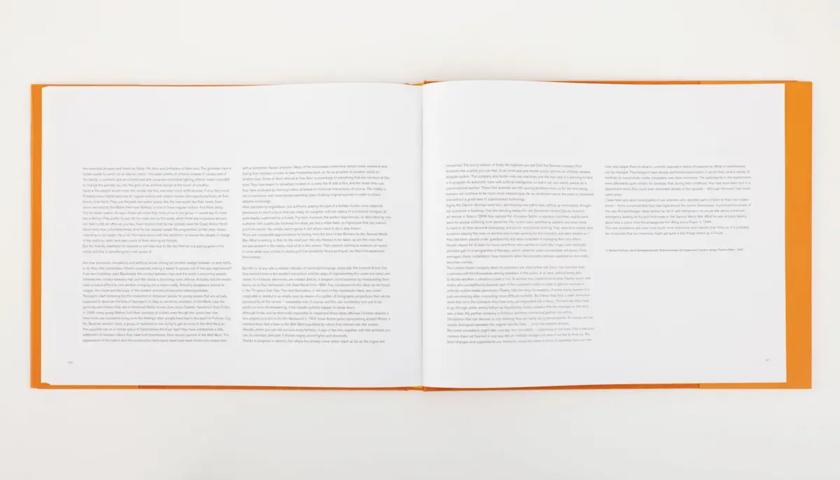 Open book with orange cover lying open on a white surface; pages filled with dense small text.