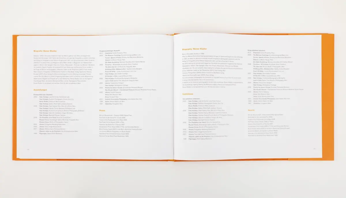 Open orange-covered book on a white surface, two-page spread of biographies and exhibitions text.