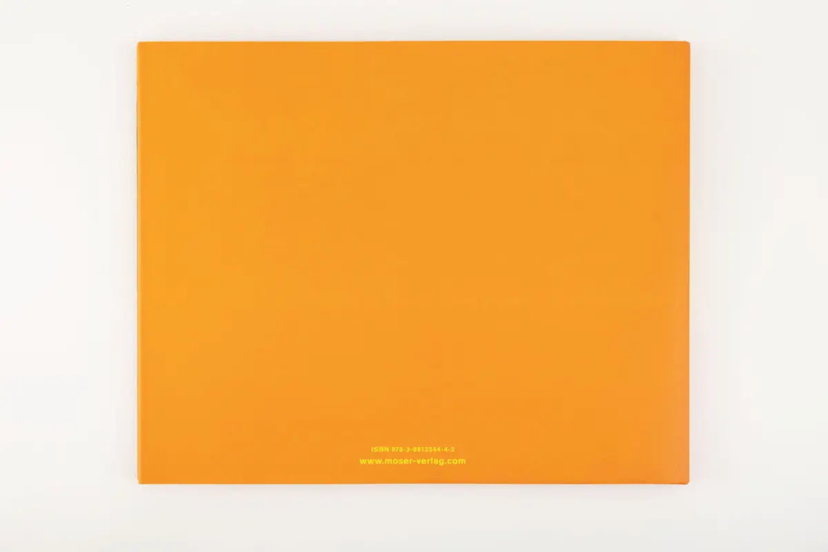 Orange book cover lying flat on a white background.