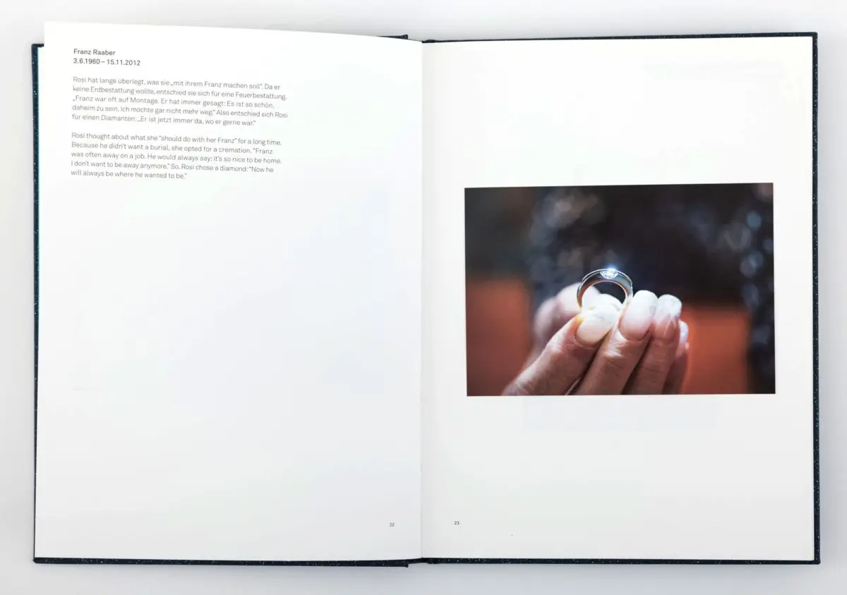 Open book with text on left; right page shows hands holding a diamond ring against a blurred background.