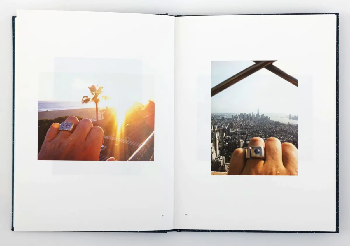 Open book with two photos: left shows a hand wearing a ring on a sunlit beach boardwalk; right shows a hand wearing a ring over a city skyline.