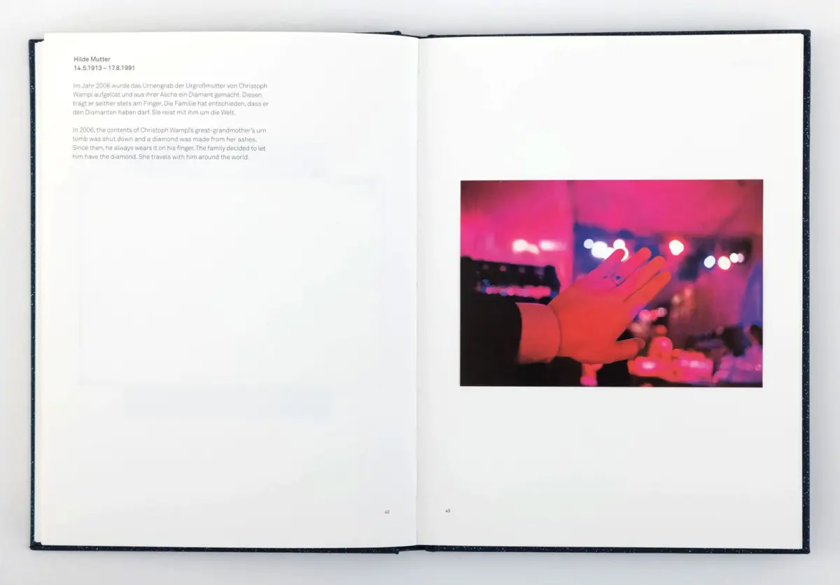Open book spread; right page shows a hand reaching up before blurred neon stage lights.