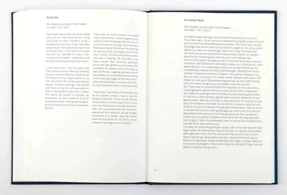 Open hardcover book laid flat, two-page spread with English left and German right, page 115 visible.
