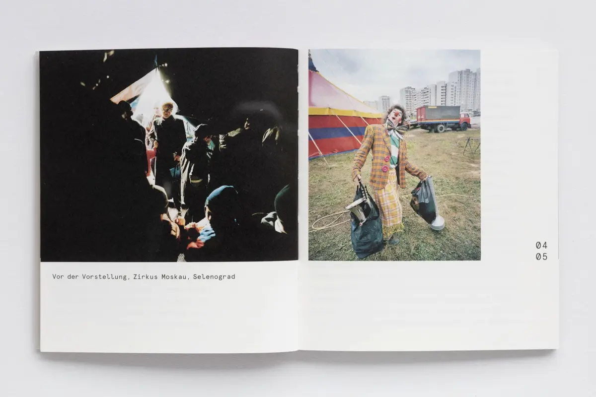 Two-page spread: left shows audience in dark backstage; right shows clown in plaid suit with bags near striped circus tent and city apartments.
