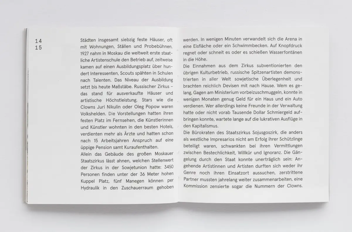 Open two-page book with dense German text, resting on a white surface.