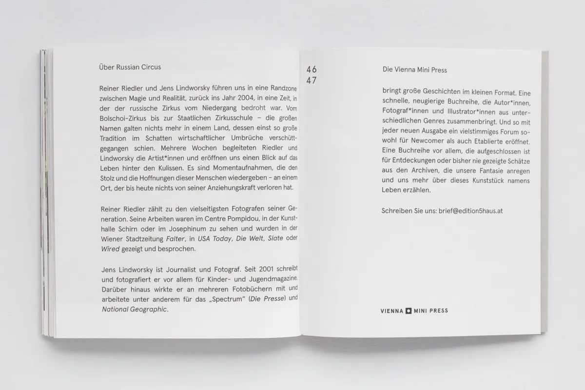 Open book resting on a white surface, two pages of dense German text.