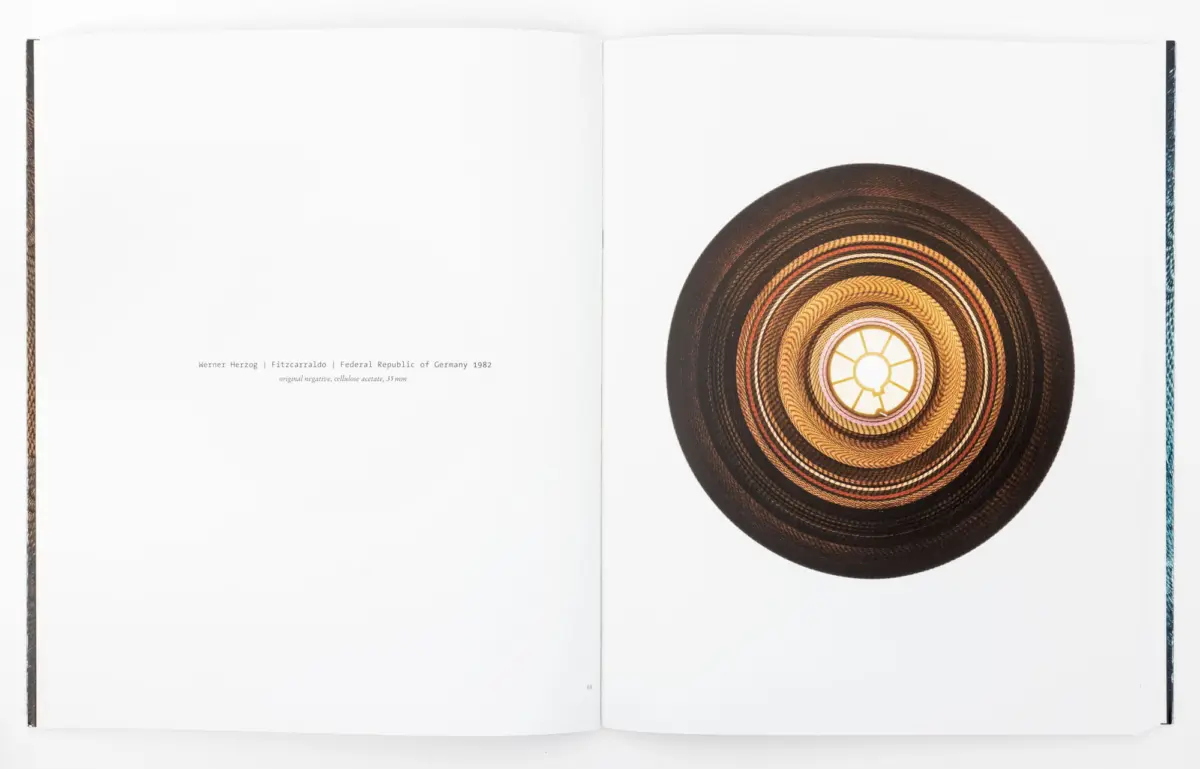 Open book spread featuring a large circular woven straw hat on the right page.