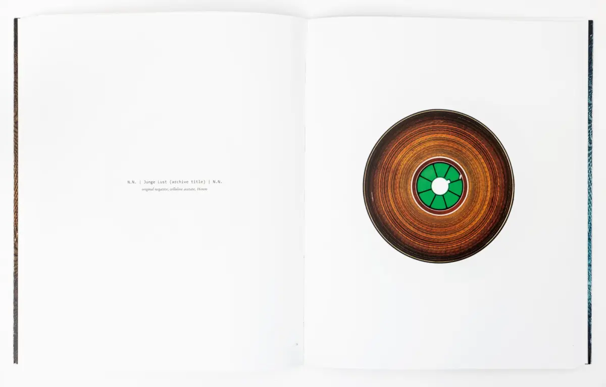 Open book showing a brown vinyl record with a green center label on the right page.