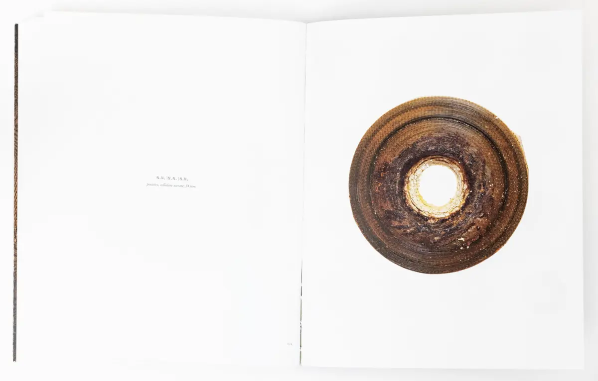 Open book with a large rusty circular metal disk on the right page.