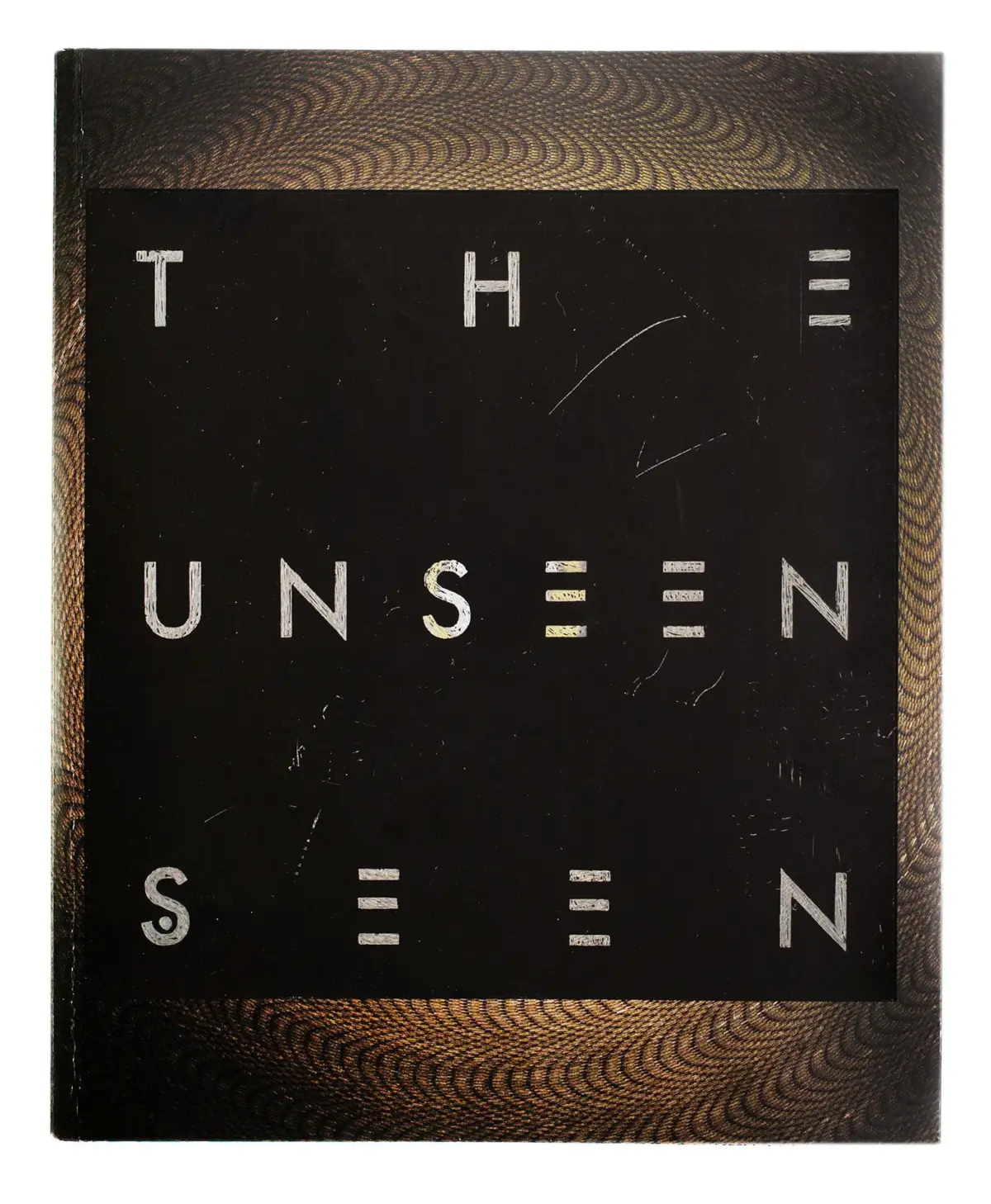 Wooden-framed black chalkboard displaying the phrase THE UNSEEN in white letters.