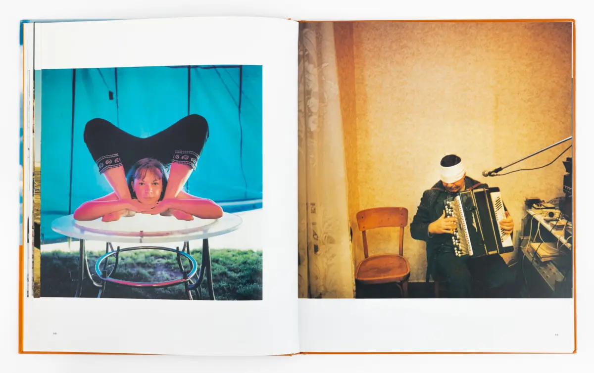 Open book spread: left image shows a person in a backbend on a round table before a blue backdrop; right image shows a man with a white headband playing an accordion indoors.