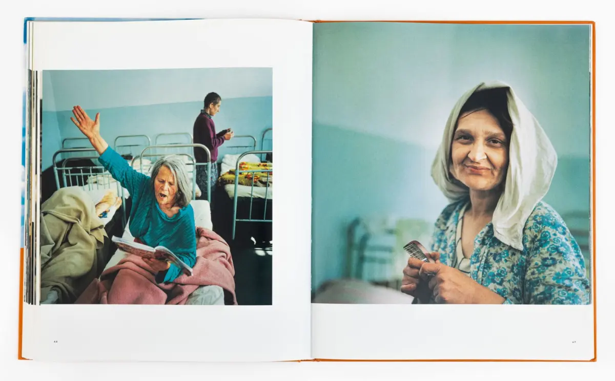 Open book with two photos: left elderly woman in blue in a hospital bed raising her arm; right smiling woman wearing headscarf and floral dress.