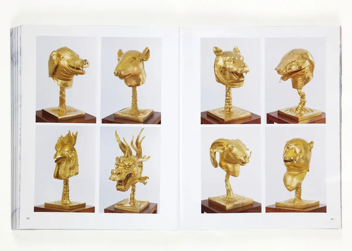 Eight golden animal-head busts mounted on textured neck stems, each on a wooden base, displayed on a two-page book spread.
