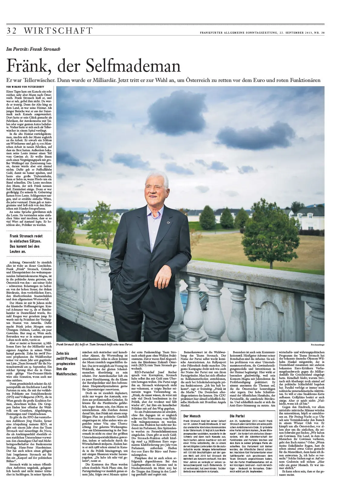 Portrait of an elderly person in a dark suit, leaning on a stone balustrade on an outdoor terrace under a cloudy sky.