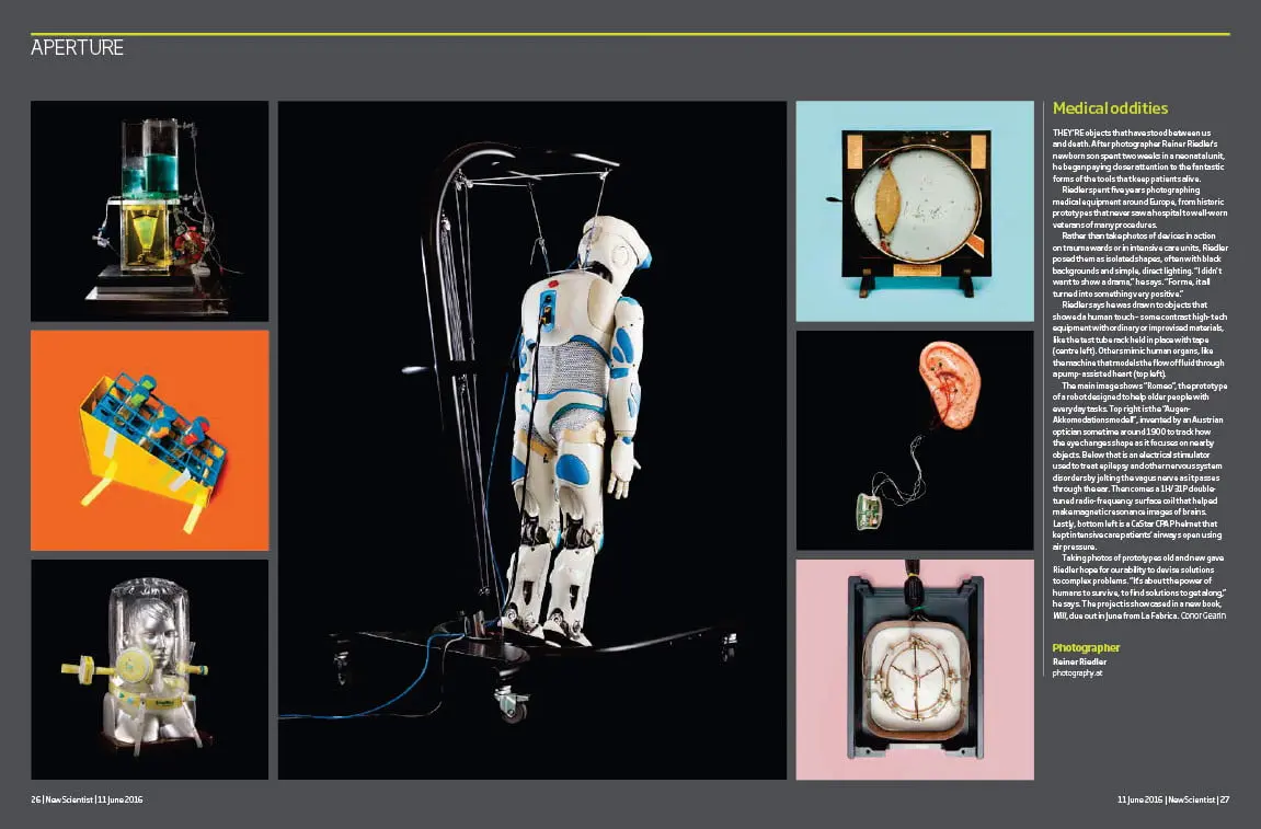 Humanoid robot sculpture suspended by cables on a dark stage, with surrounding small science-device photographs.