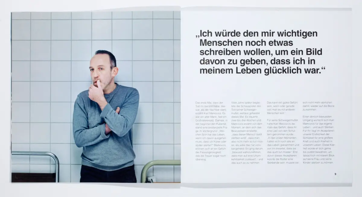 Adult person in a gray sweater stands with finger to lips beside a tiled wall; opposite page features a large German quote.
