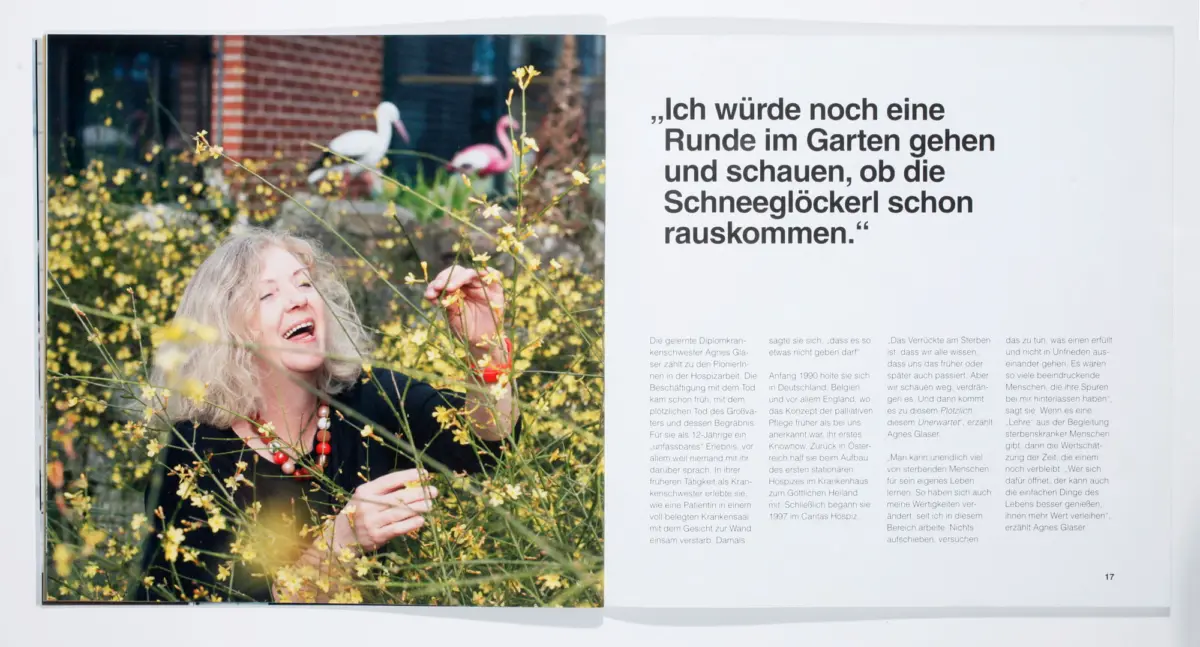 Older person with gray hair laughs in a garden among yellow blossoms; a magazine spread featuring a large German quote on the right.