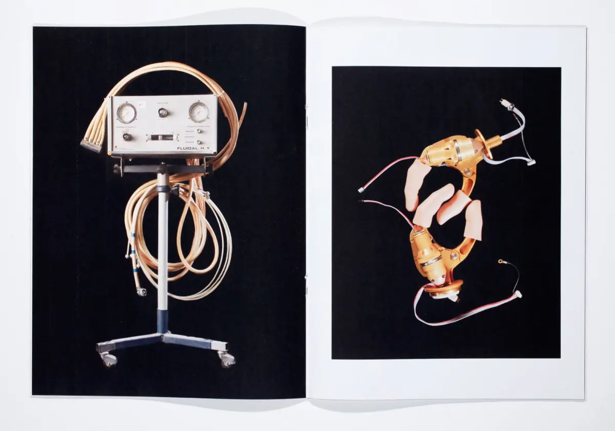 Two-page spread: left vintage instrument panel with gauges and coiled cables on a wheeled stand; right gold robotic arm with wires.