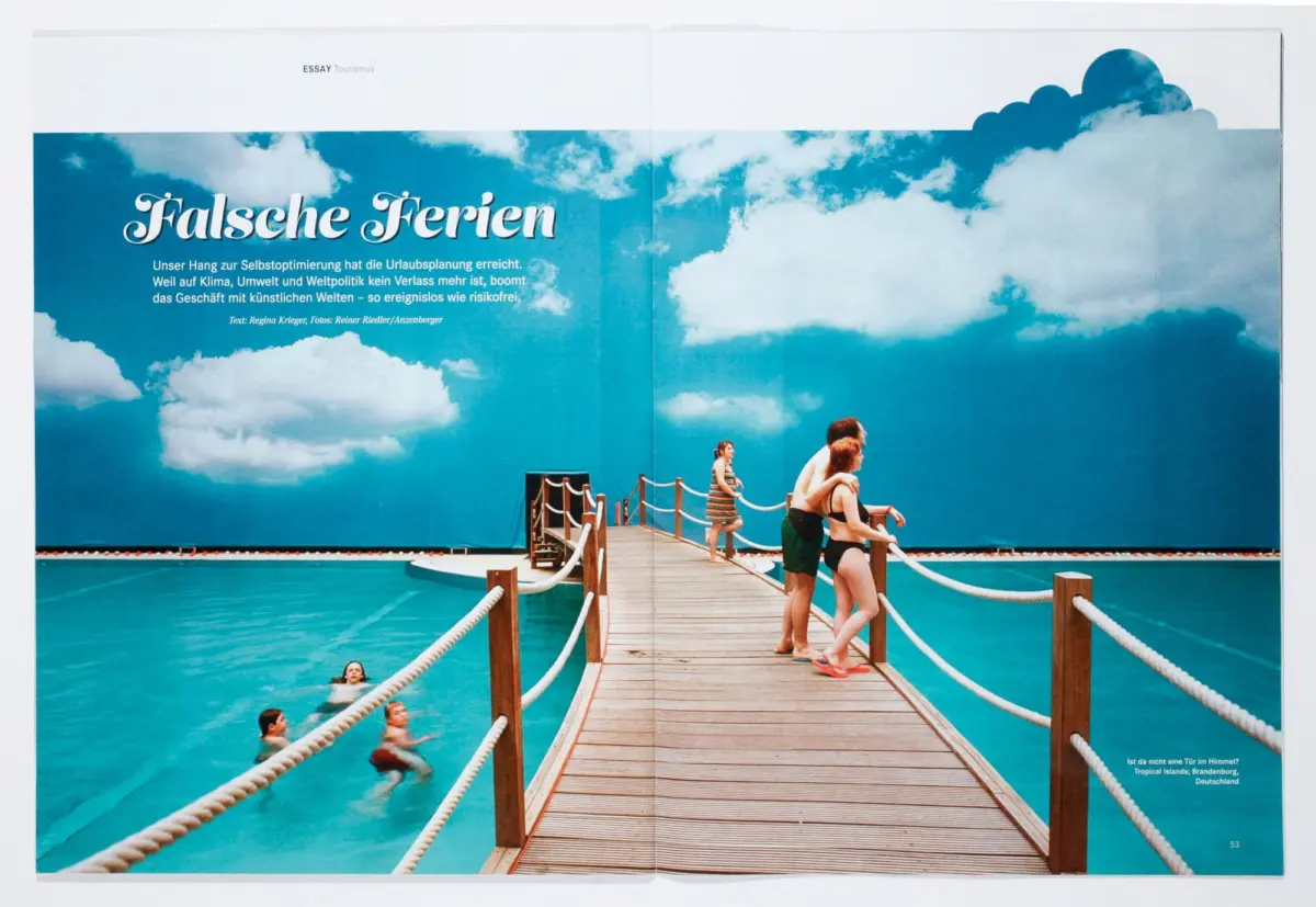 Wooden pier over turquoise water, people in swimsuits leaning on railings and swimming, under a cloudy blue sky mural.