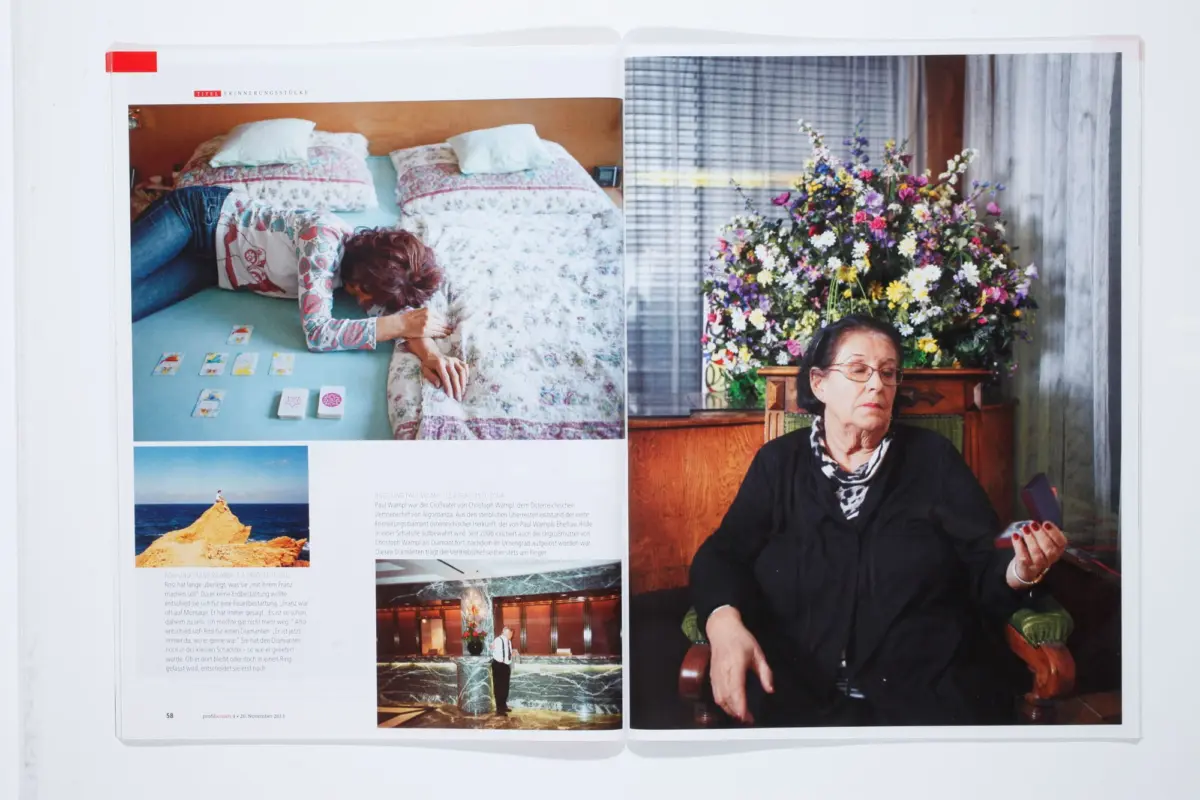 Open magazine spread; left shows a person lying on a patterned bed, right shows an elderly woman seated beside a large colorful flower arrangement.