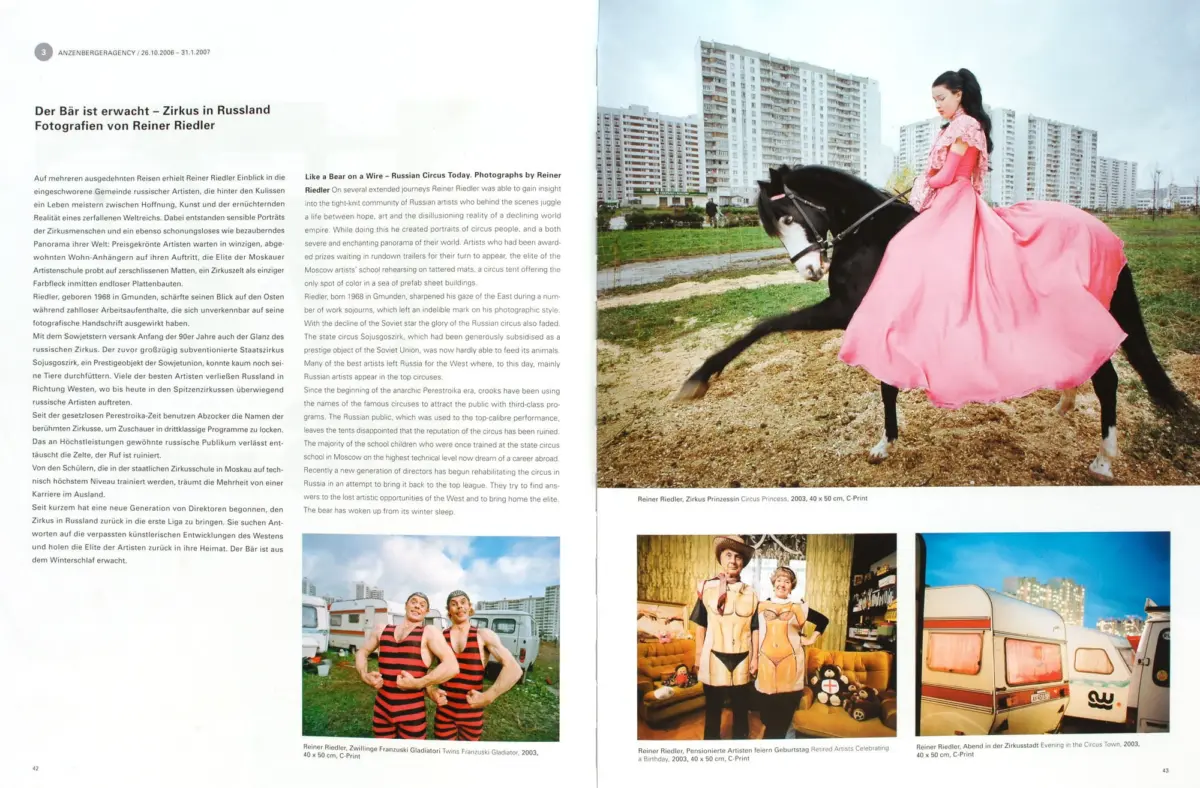 Young woman in a pink gown rides a black horse across a grassy field with high-rise apartments in the background.