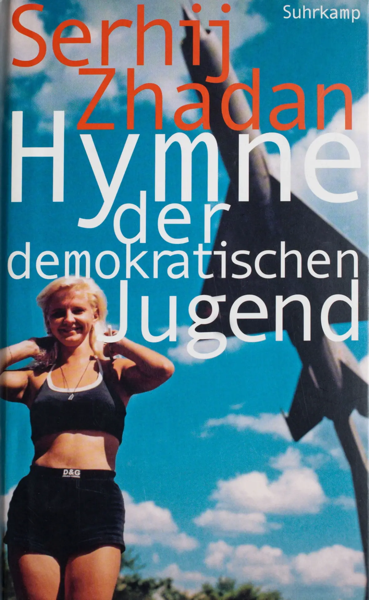 Book cover showing an athletic person running outdoors in black sportswear under a blue, cloudy sky; large orange and white title text overlays.