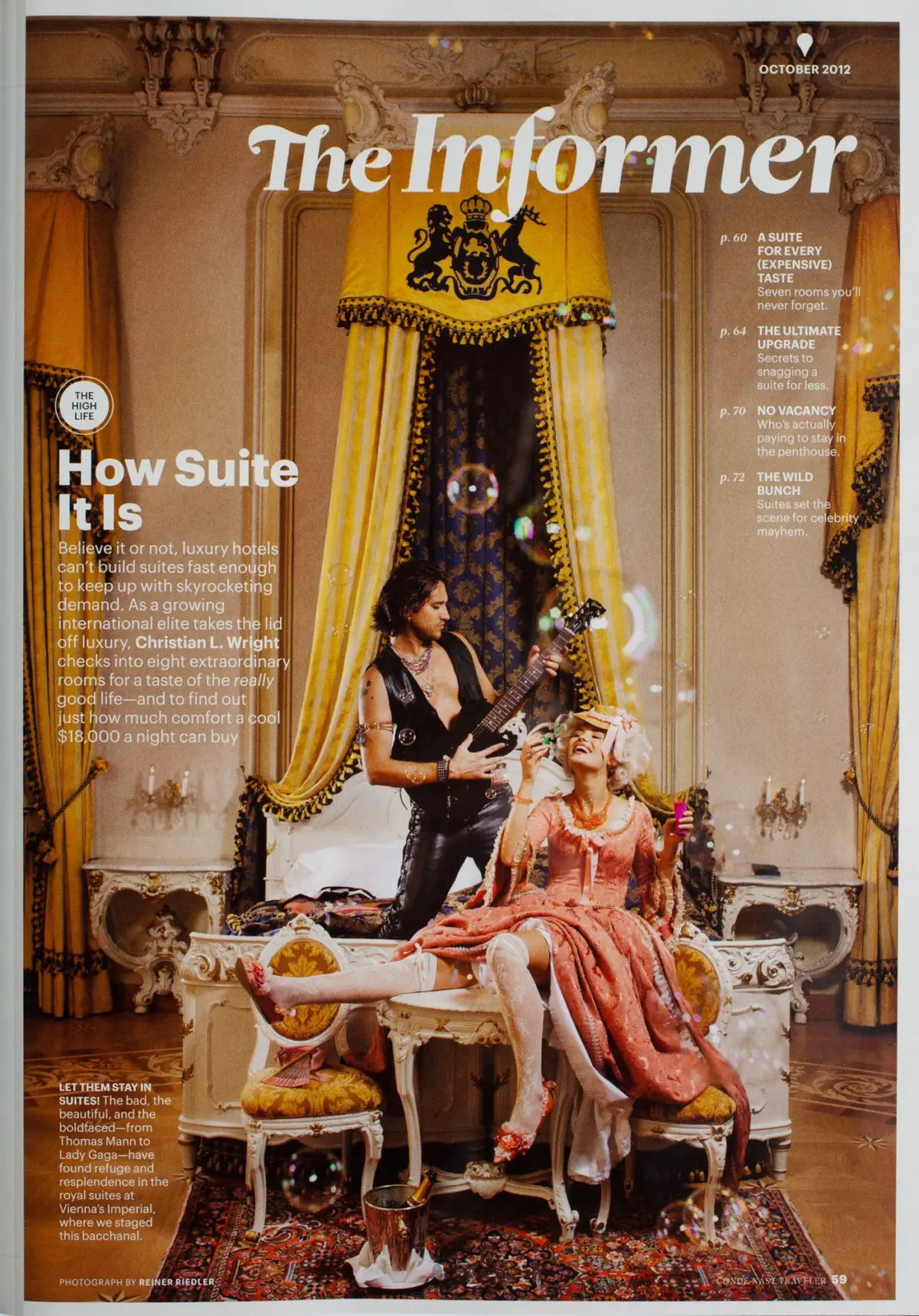 Guitarist plays electric guitar next to a woman in pink gown on an ornate canopy bed in a luxurious royal-style suite.