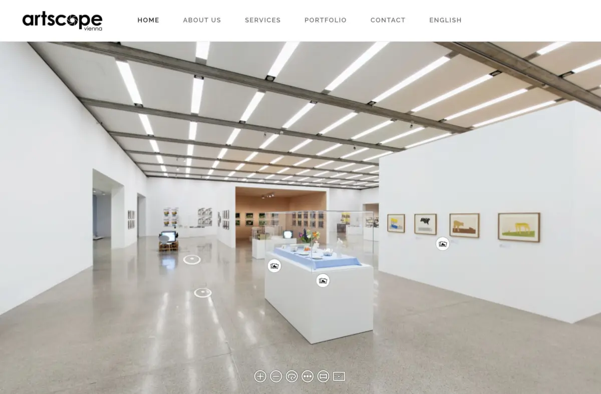 Modern art gallery interior with white walls, polished floor, skylight-grid ceiling, framed works on walls, and white display pedestals.