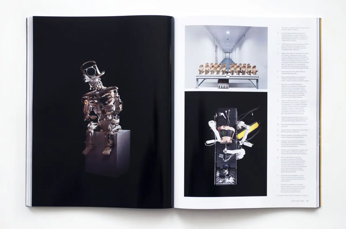 Metallic robotic sculpture displayed on a pedestal against a black page; right page shows a row of prosthetic hands on a table and a tall mechanical collage.