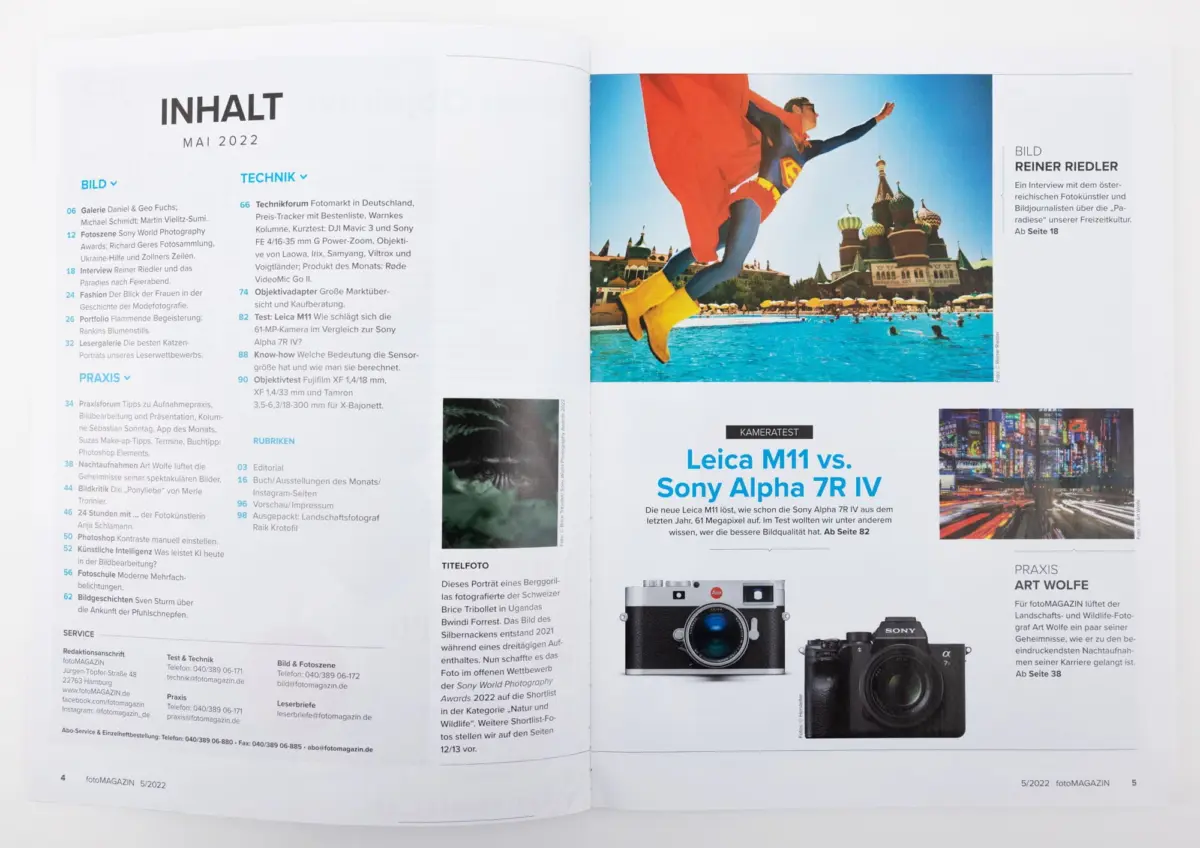 Open magazine spread with a person in a red superhero cape leaping over a blue pool, Moscow skyline and Saint Basil's Cathedral in the background.