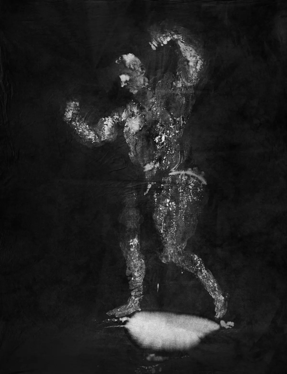 Abstract silhouette of a person dancing, created from white speckles on a dark background, arms raised.