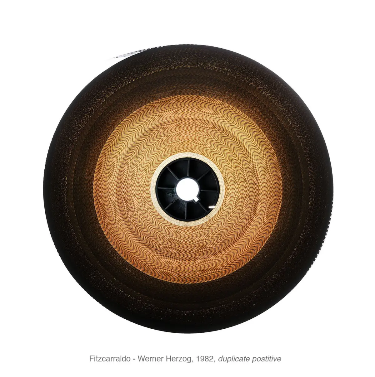 Top-down view of a circular sculpture with concentric brown rings and a central black hub.