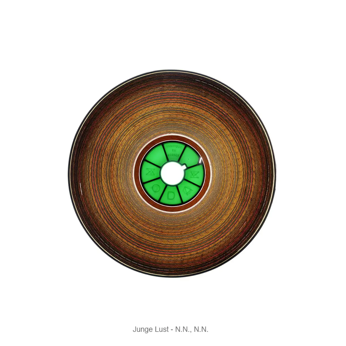 Top-down view of a circular wooden disc with concentric rings and a bright green segmented inner dial surrounding a white center hole.