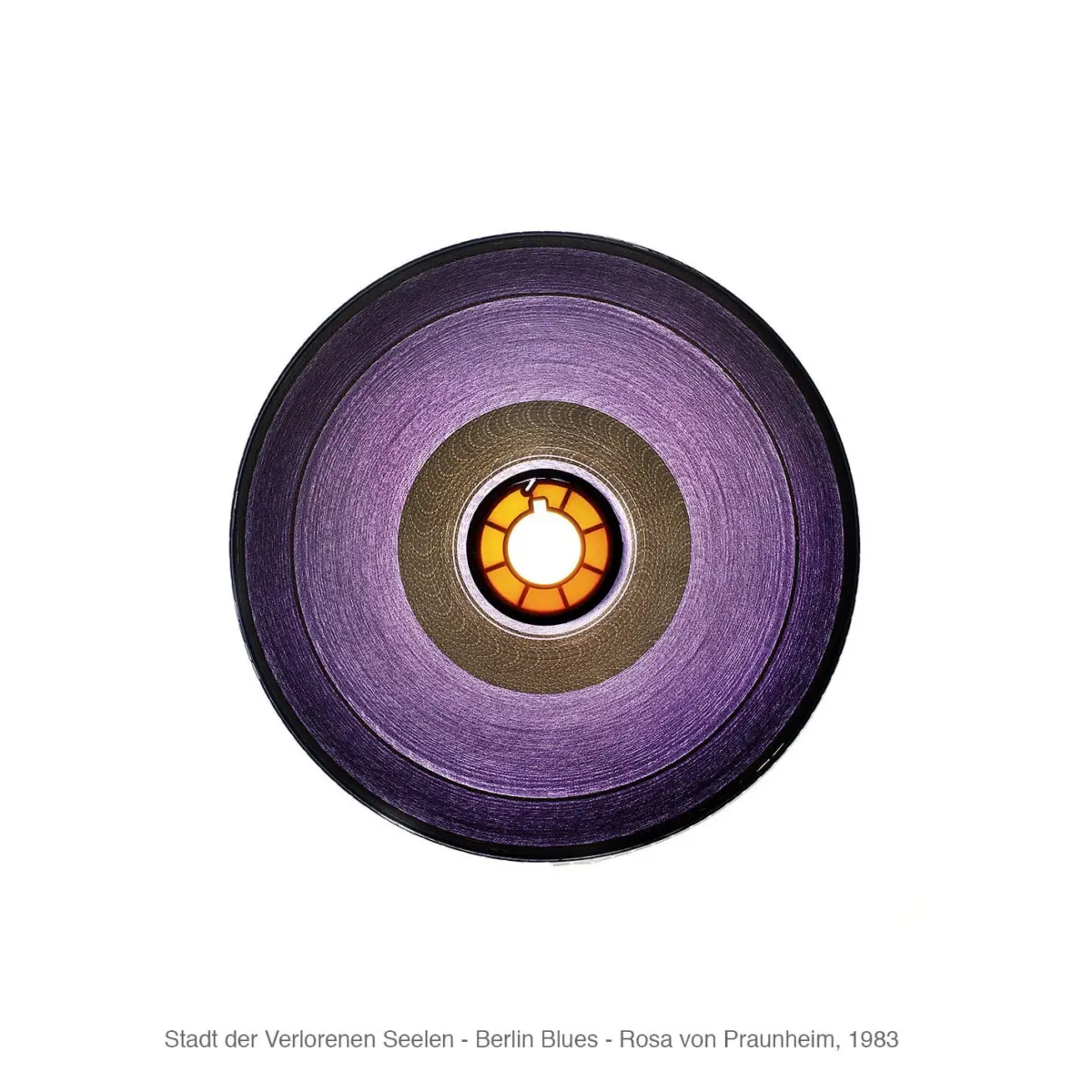 Close-up of a circular disc with purple gradient rings and an orange center against a white background.