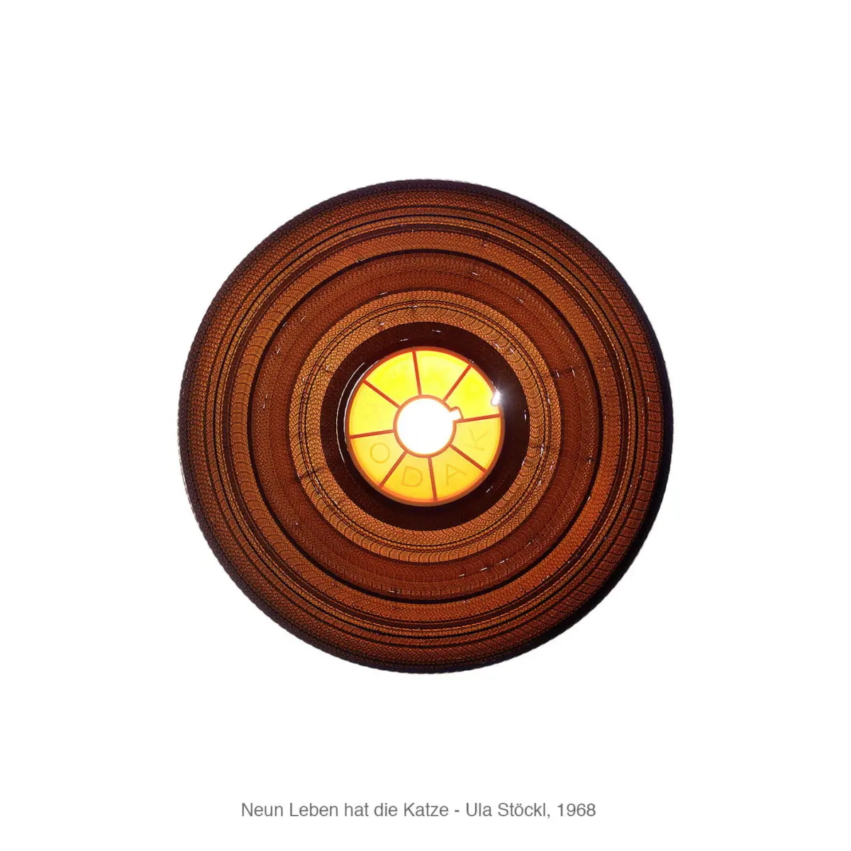 Circular orange concentric-ring lamp with bright yellow center, isolated on white.
